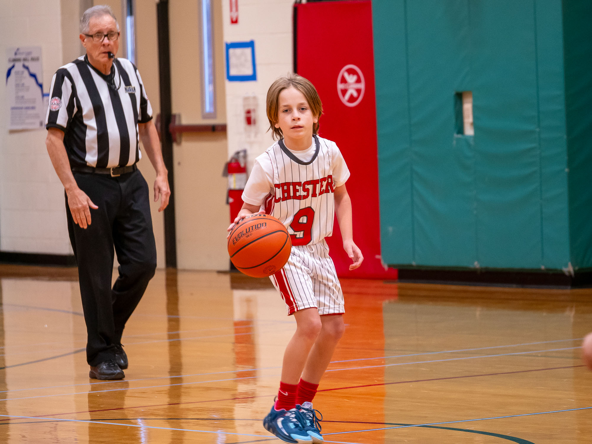 Young Chester #9 dribbling with referee